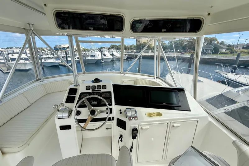 Slide: The Image of Helm of 2000 Ocean Yachts 48, featuring modern controls and panoramic marina view. - 28
