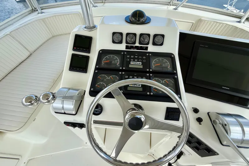 Slide: The Image of Helm of 2000 Ocean Yachts 48 with gauges, steering wheel, and navigation equipment. - 29