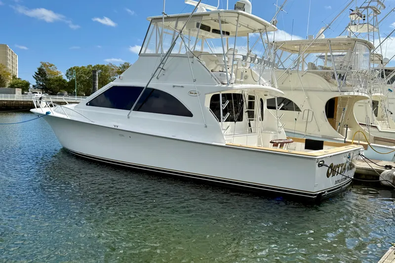 Slide: The Image of 2000 Ocean Yachts 48 model docked in a marina under a clear blue sky. - 32