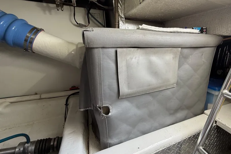 Slide: The Image of Engine room of a 2000 Ocean Yachts 48, featuring insulated components and piping. - 34