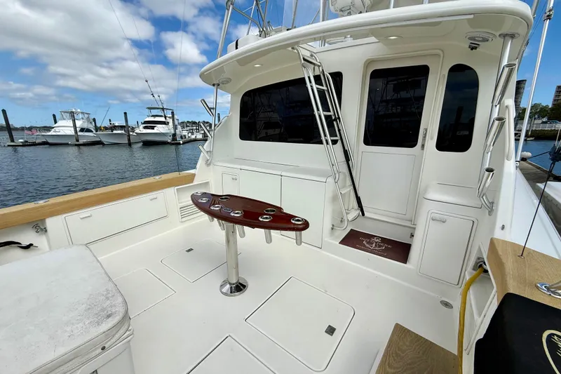 Slide: The Image of Ocean Yachts 48, 2000 model, featuring spacious deck and fishing amenities at marina. - 37