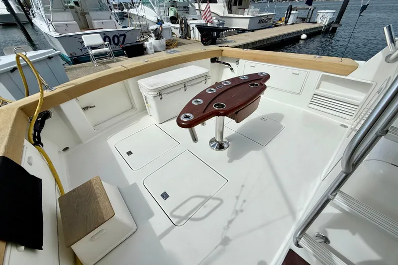 Slide: The Image of Spacious deck of 2000 Ocean Yachts 48, featuring fishing rod holders and storage compartments. - 38