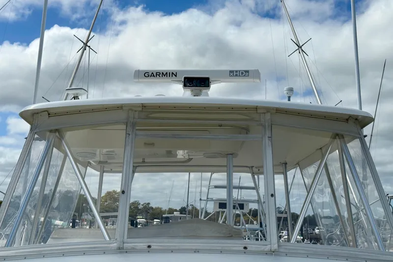 Slide: The Image of Ocean Yachts 48, 2000 model, featuring Garmin xHD2 radar, docked under cloudy sky. - 43