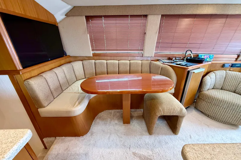 Slide: The Image of Luxurious interior of a 2000 Ocean Yachts 48, featuring a cozy dining area and modern amenities. - 6