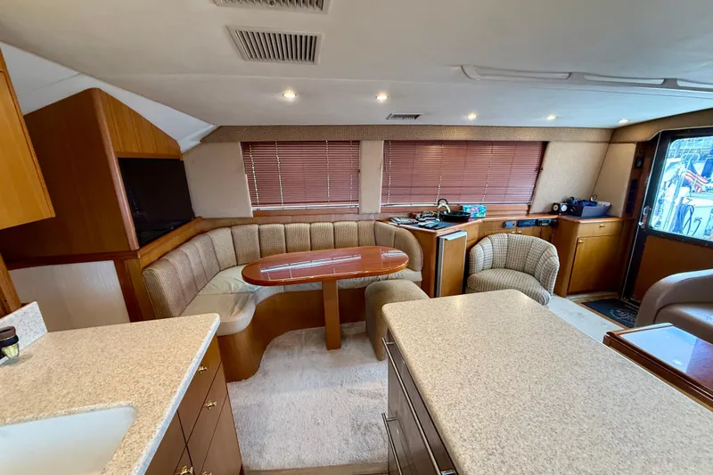 Slide: The Image of Luxurious interior of a 2000 Ocean Yachts 48, featuring a cozy dining area and modern amenities. - 7
