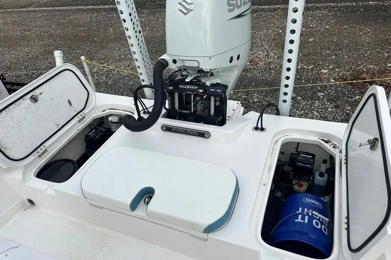 Slide: The Image of 2021 Shallow Sport 24 Modified V boat on water, featuring Suzuki engine. - 10