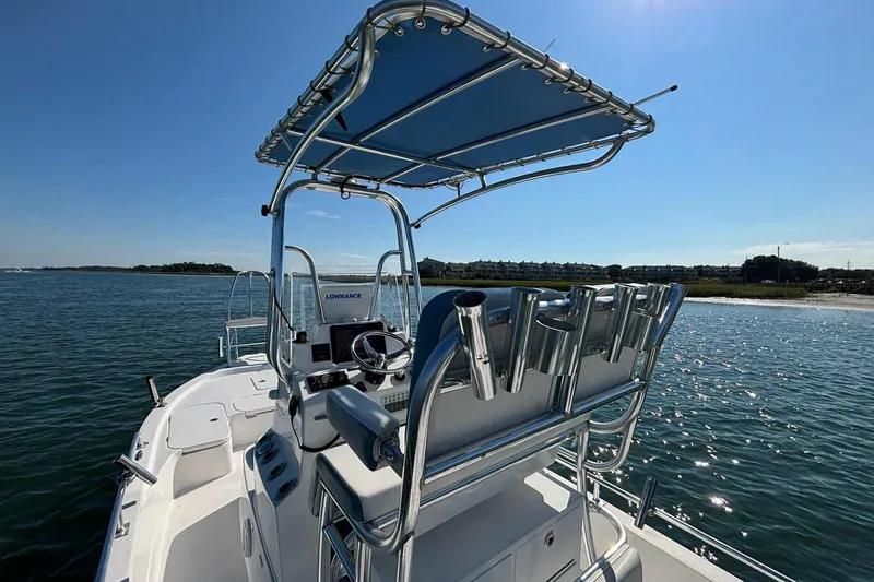 Slide: The Image of 2021 Shallow Sport 24 Modified V boat on water, featuring a sleek design and modern equipment. - 16