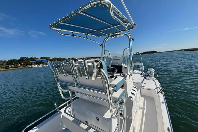 Slide: The Image of 2021 Shallow Sport 24 Modified V boat on water, featuring a sleek design and modern equipment. - 17