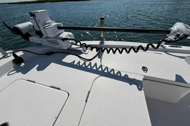 Slide: The Image of 2021 Shallow Sport 24 Modified V boat with Minn Kota trolling motor on deck. - 21