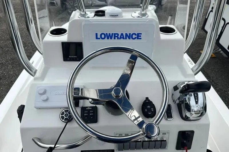 Slide: The Image of 2021 Shallow Sport 24 Modified V boat console with Lowrance electronics and steering wheel. - 24