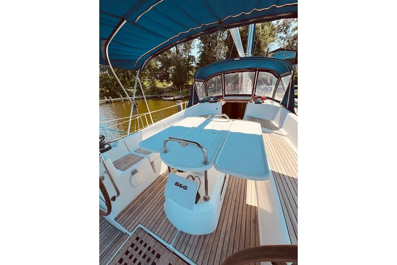 Slide: The Image of 2008 Jeanneau Sun Odyssey 45 DS sailboat cockpit with blue canopy and wooden deck. - 10