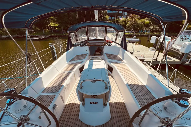 Slide: The Image of 2008 Jeanneau Sun Odyssey 45 DS sailboat cockpit with dual steering wheels and teak seating. - 13