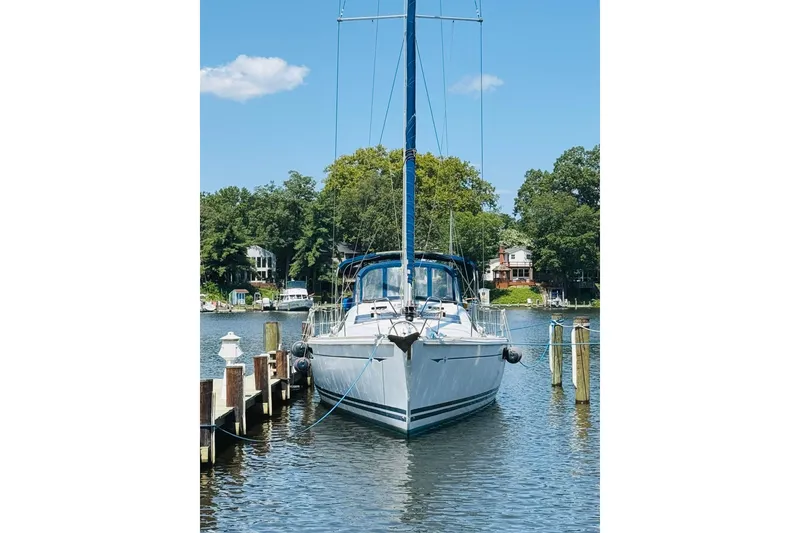 Slide: The Image of 2008 Jeanneau Sun Odyssey 45 DS sailboat docked on a serene lake. - 2
