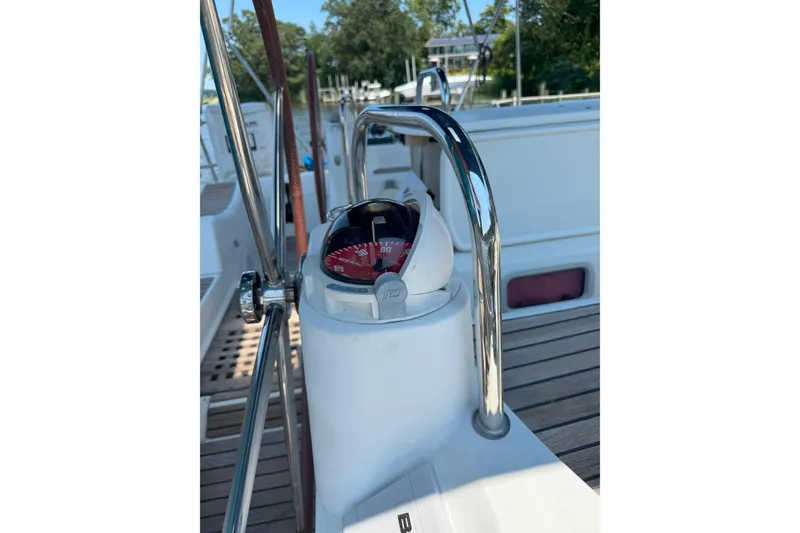 Slide: The Image of Compass on Jeanneau Sun Odyssey 45 DS yacht, 2008 model, with wooden deck background. - 22