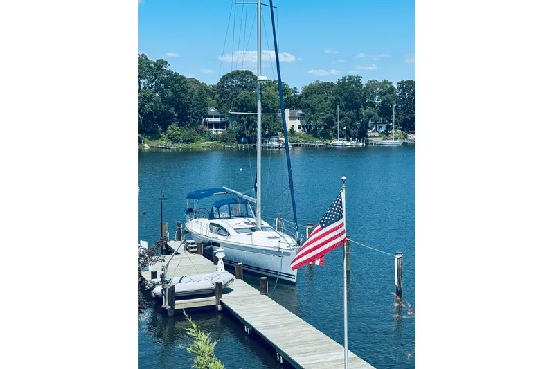 Slide: The Image of Jeanneau Sun Odyssey 45 DS sailboat docked by a lake with American flag, 2008 model. - 3