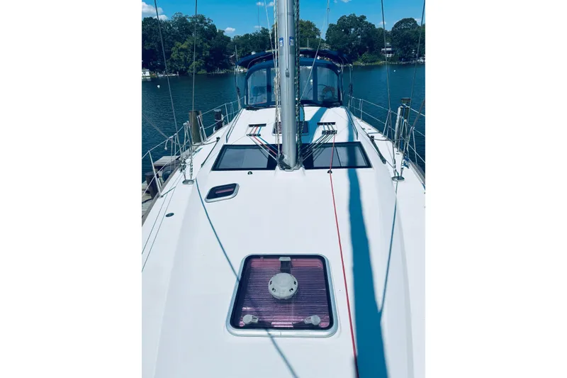 Slide: The Image of 2008 Jeanneau Sun Odyssey 45 DS sailboat deck with blue canopy, docked by a lake. - 30