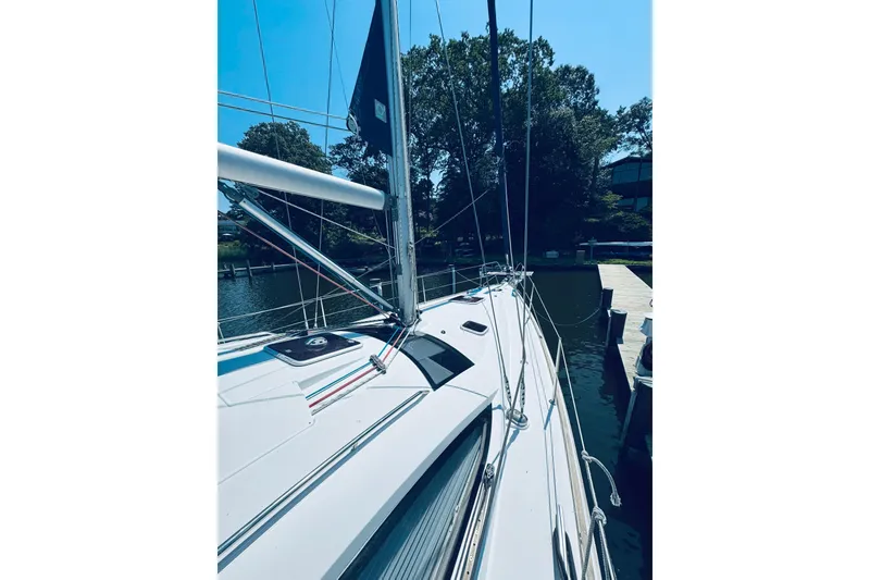 Slide: The Image of 2008 Jeanneau Sun Odyssey 45 DS sailboat docked by a serene waterfront. - 38