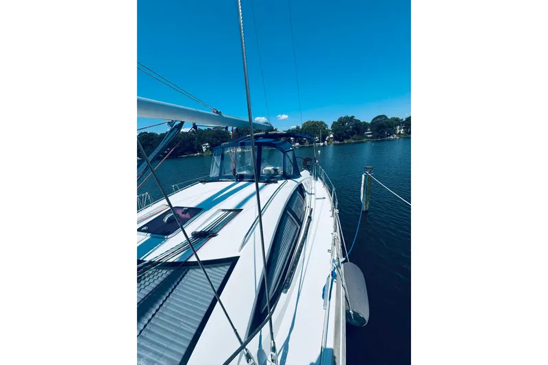 Slide: The Image of 2008 Jeanneau Sun Odyssey 45 DS sailboat docked on a serene lake under clear blue skies. - 40