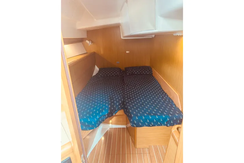 Slide: The Image of Cozy cabin interior of 2008 Jeanneau Sun Odyssey 45 DS with nautical-themed bedding. - 46