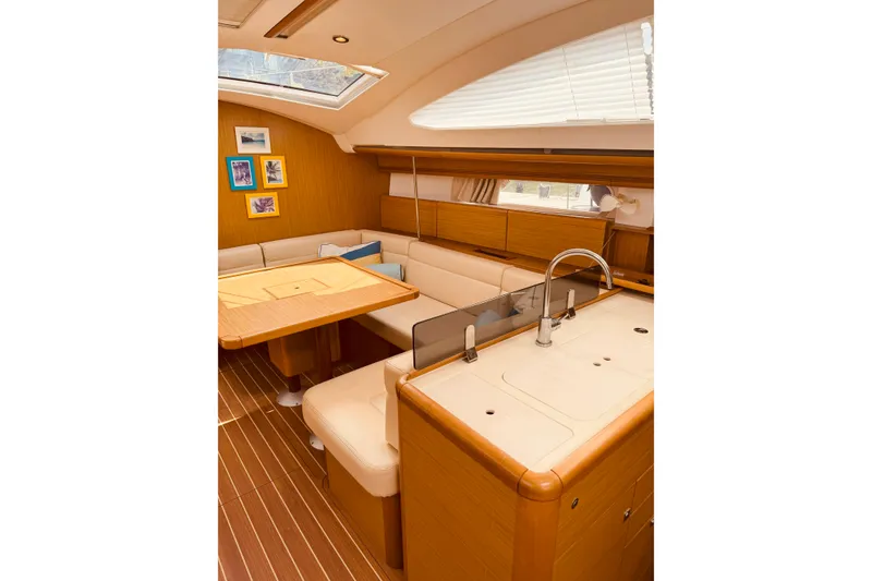 Slide: The Image of Interior of 2008 Jeanneau Sun Odyssey 45 DS yacht, featuring elegant wood finishes and cozy seating. - 49