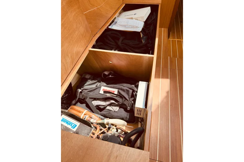 Slide: The Image of Storage compartment on 2008 Jeanneau Sun Odyssey 45 DS sailboat, containing ropes and equipment. - 52