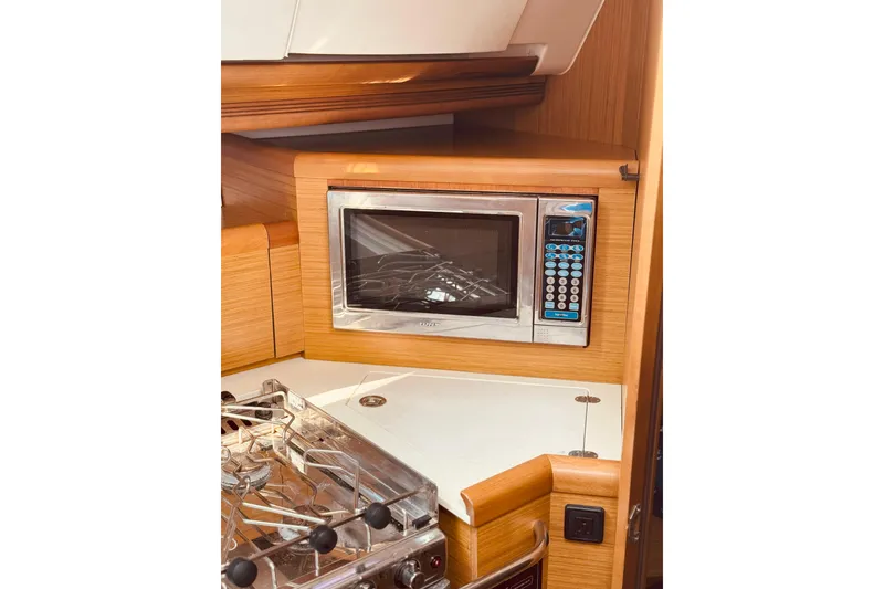 Slide: The Image of Microwave and stove in 2008 Jeanneau Sun Odyssey 45 DS yacht kitchen. - 57