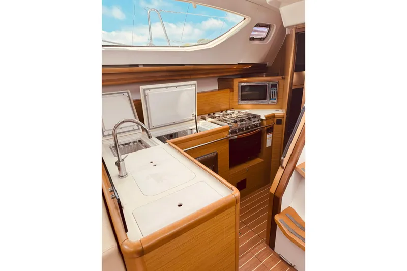 Slide: The Image of 2008 Jeanneau Sun Odyssey 45 DS yacht kitchen with modern appliances and wood finish. - 58