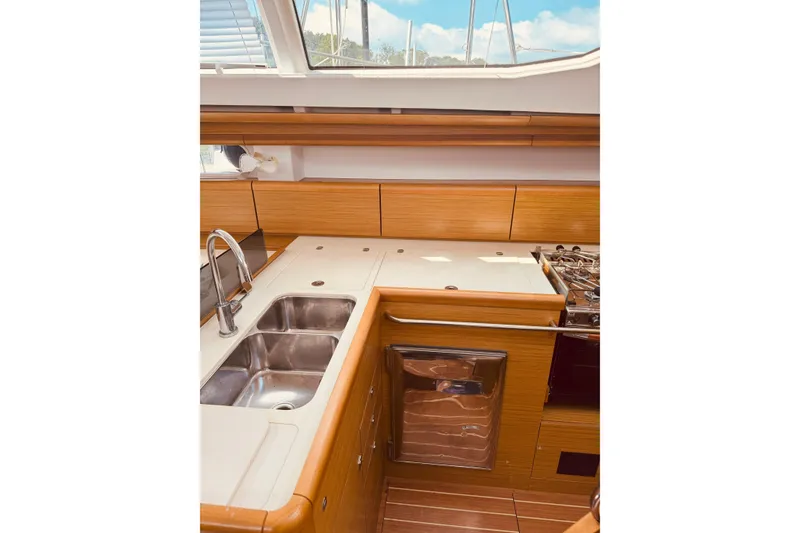 Slide: The Image of Interior of 2008 Jeanneau Sun Odyssey 45 DS yacht kitchen with wood finish and stainless steel sink. - 59