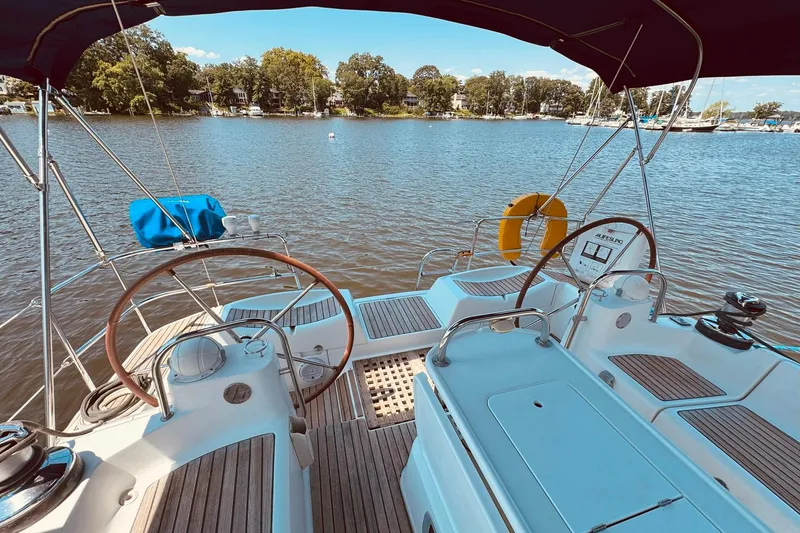 Slide: The Image of Cockpit view of 2008 Jeanneau Sun Odyssey 45 DS sailboat on a serene lake. - 6
