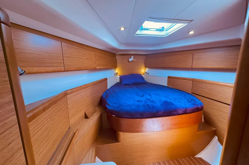 Slide: The Image of Luxurious cabin interior of 2008 Jeanneau Sun Odyssey 45 DS sailboat with wood finish. - 60