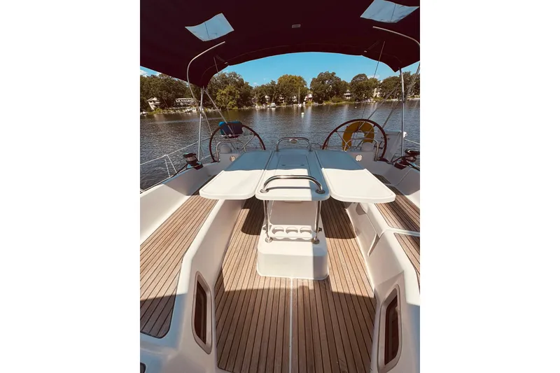 Slide: The Image of Cockpit view of 2008 Jeanneau Sun Odyssey 45 DS sailboat on a serene lake. - 7