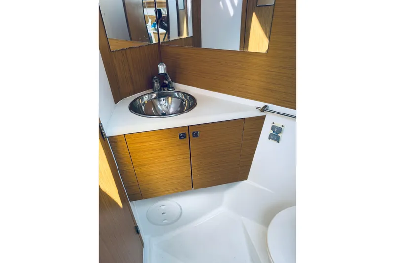 Slide: The Image of Compact bathroom with wooden cabinetry and stainless steel sink on Jeanneau Sun Odyssey 45 DS yacht. - 72