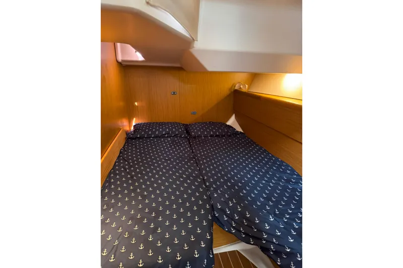 Slide: The Image of Cozy cabin interior of 2008 Jeanneau Sun Odyssey 45 DS with anchor-patterned bedding. - 73