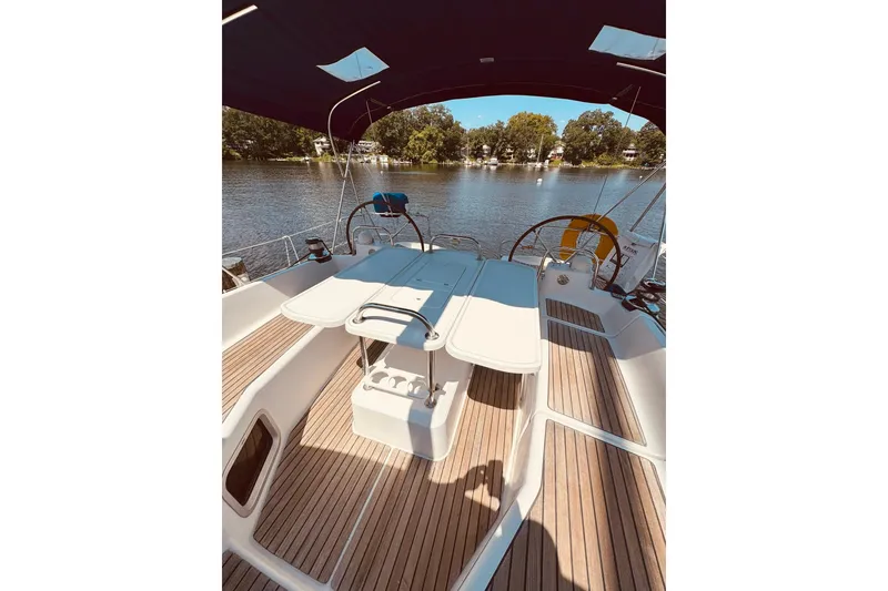 Slide: The Image of Cockpit of 2008 Jeanneau Sun Odyssey 45 DS sailboat with wooden deck and seating. - 9