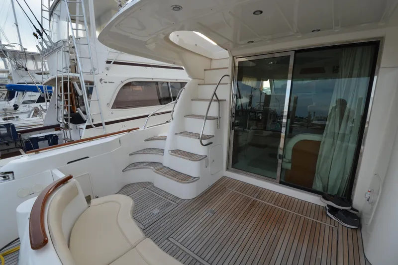 Slide: The Image of 2007 Jeanneau Prestige 46 yacht deck with stairs and sliding glass door. - 10