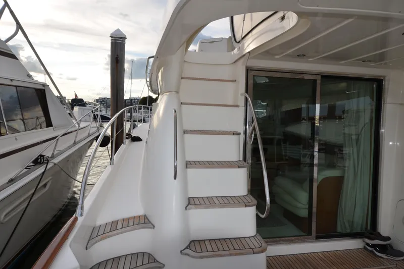 Slide: The Image of 2007 Jeanneau Prestige 46 yacht with elegant staircase and sliding glass door. - 12