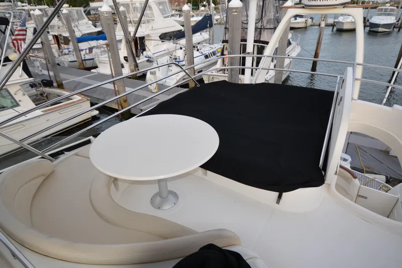 Slide: The Image of 2007 Jeanneau Prestige 46 yacht deck with seating and table at marina. - 16