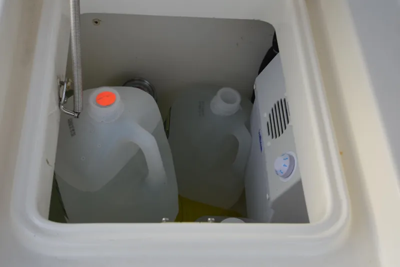 Slide: The Image of Storage compartment on a 2007 Jeanneau Prestige 46 yacht with water jugs and equipment. - 17