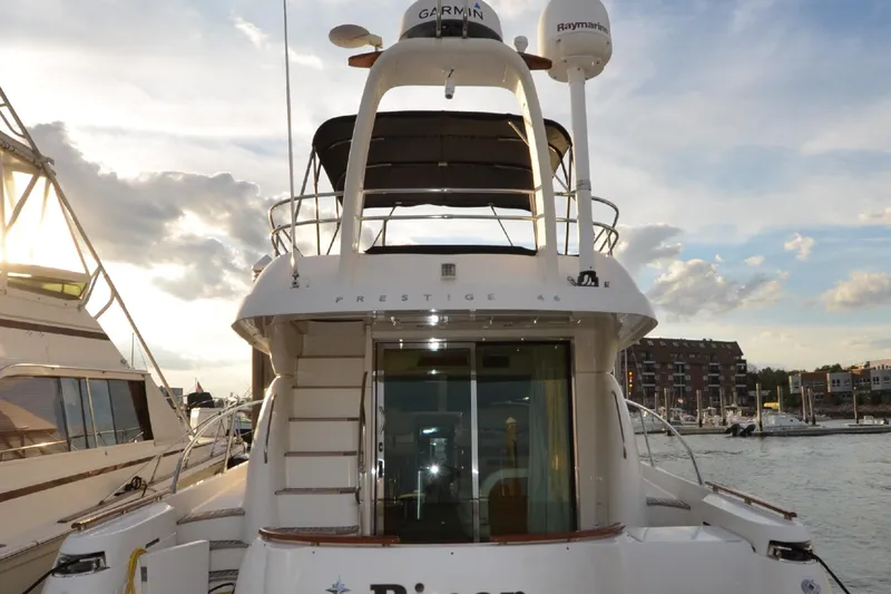 Slide: The Image of 2007 Jeanneau Prestige 46 yacht docked, showcasing rear view with elegant design and modern equipment. - 19