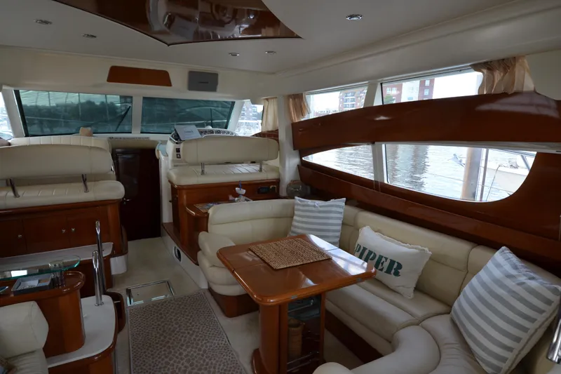 Slide: The Image of Luxurious interior of 2007 Jeanneau Prestige 46 yacht with elegant seating and large windows. - 21