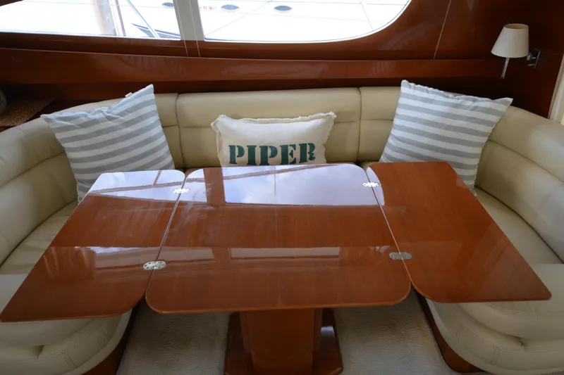 Slide: The Image of Luxurious interior of 2007 Jeanneau Prestige 46 yacht with elegant wooden table and plush seating. - 25