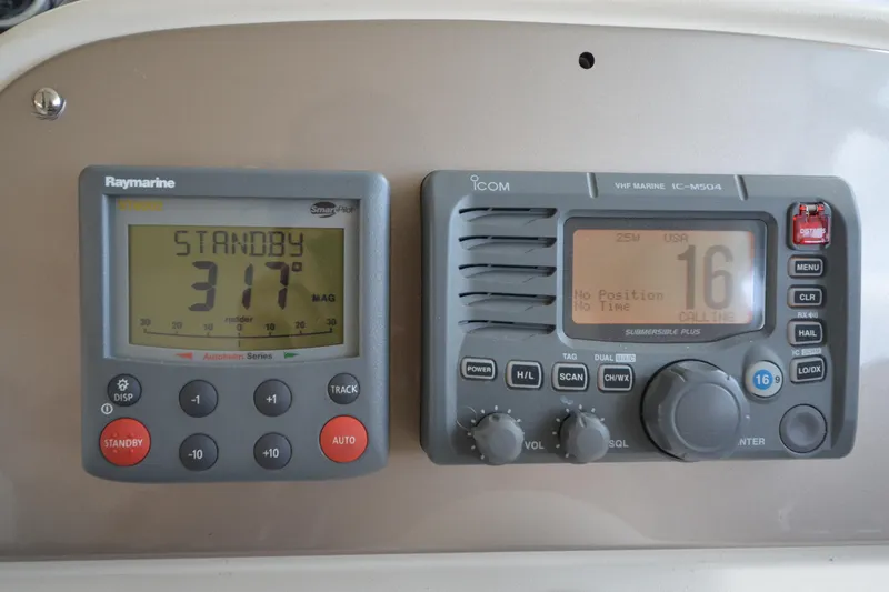 Slide: The Image of Raymarine autopilot and Icom VHF radio on 2007 Jeanneau Prestige 46 yacht dashboard. - 31