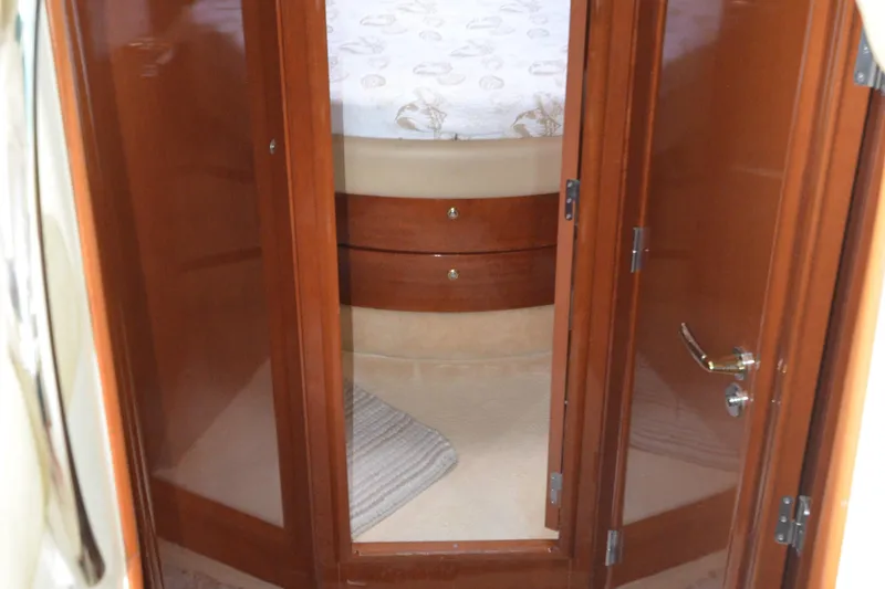 Slide: The Image of Interior cabin view of 2007 Jeanneau Prestige 46 yacht with wooden doors and cozy bedding. - 35