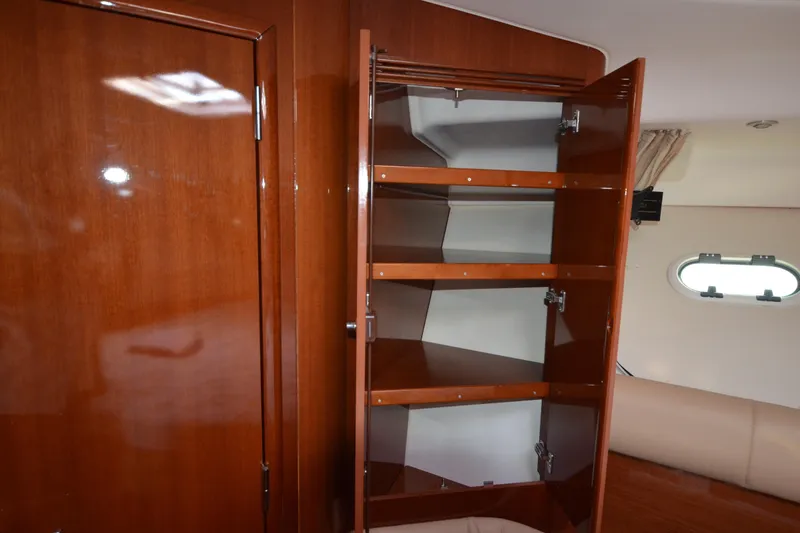 Slide: The Image of Interior of 2007 Jeanneau Prestige 46 yacht with open wooden storage cabinet. - 46
