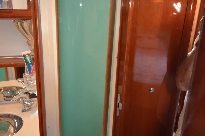 Slide: The Image of Interior of 2007 Jeanneau Prestige 46 yacht bathroom with sink and wooden finishes. - 48