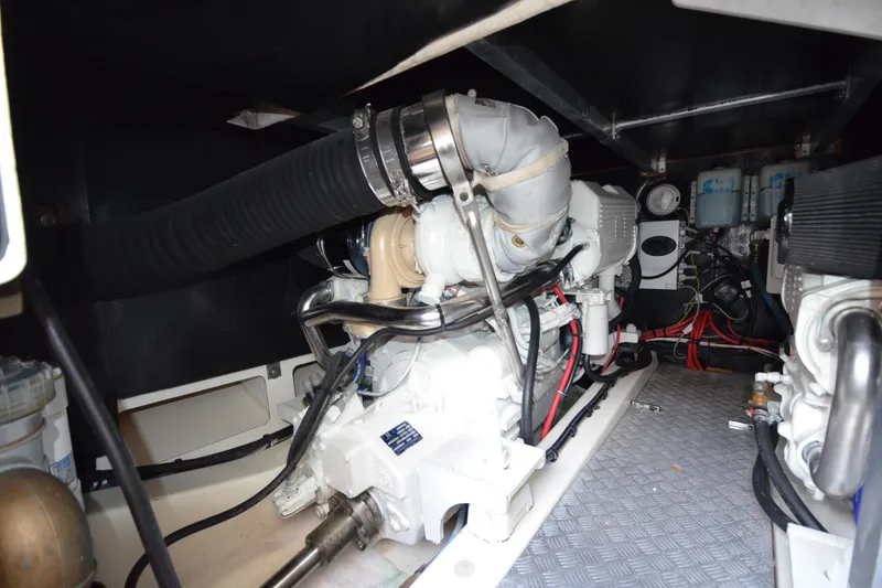 Slide: The Image of Engine room of 2007 Jeanneau Prestige 46 yacht, showcasing mechanical components and wiring. - 53