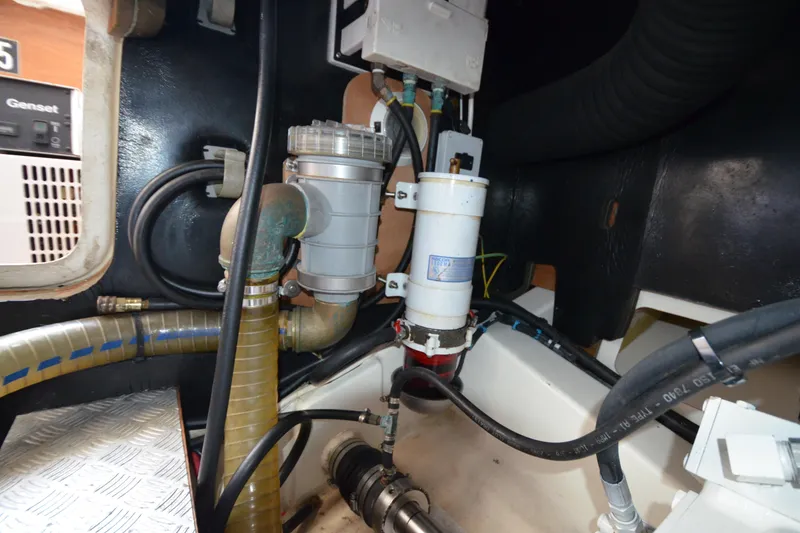 Slide: The Image of Engine room of 2007 Jeanneau Prestige 46 yacht, showcasing mechanical components and hoses. - 54