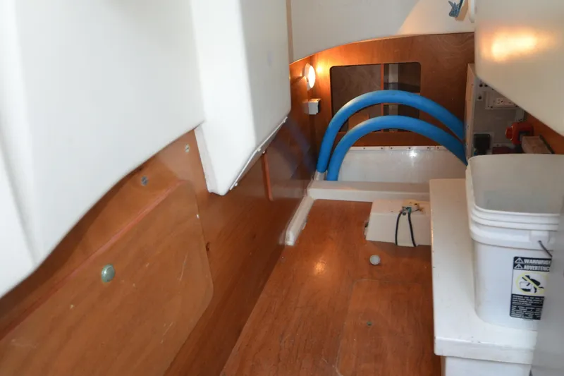 Slide: The Image of Interior of 2007 Jeanneau Prestige 46 yacht, featuring wooden flooring and storage area. - 59