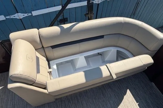 Slide: The Image of 2024 Godfrey SWEETWATER 2286 SFL boat seating with storage compartment open. - 15