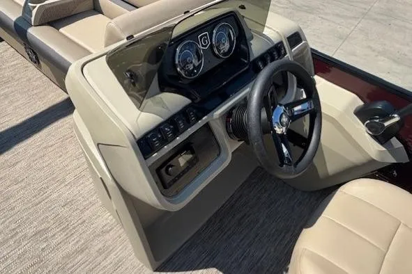 Slide: The Image of 2024 Godfrey SWEETWATER 2286 SFL boat dashboard with steering wheel and controls. - 18